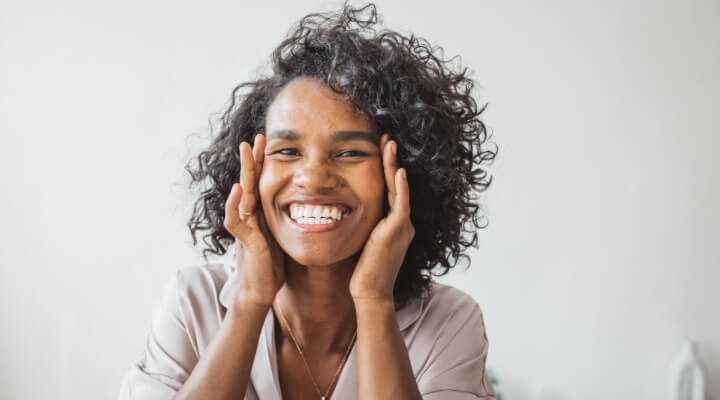 happy woman touching face